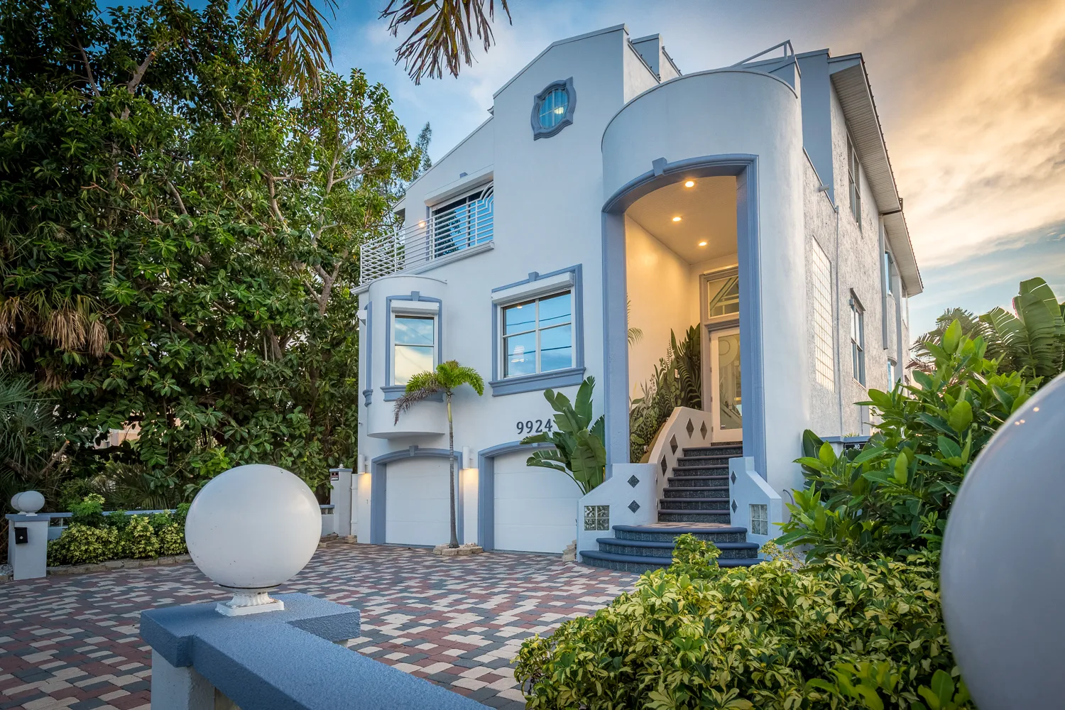 Modern white coastal vacation home exterior at dusk