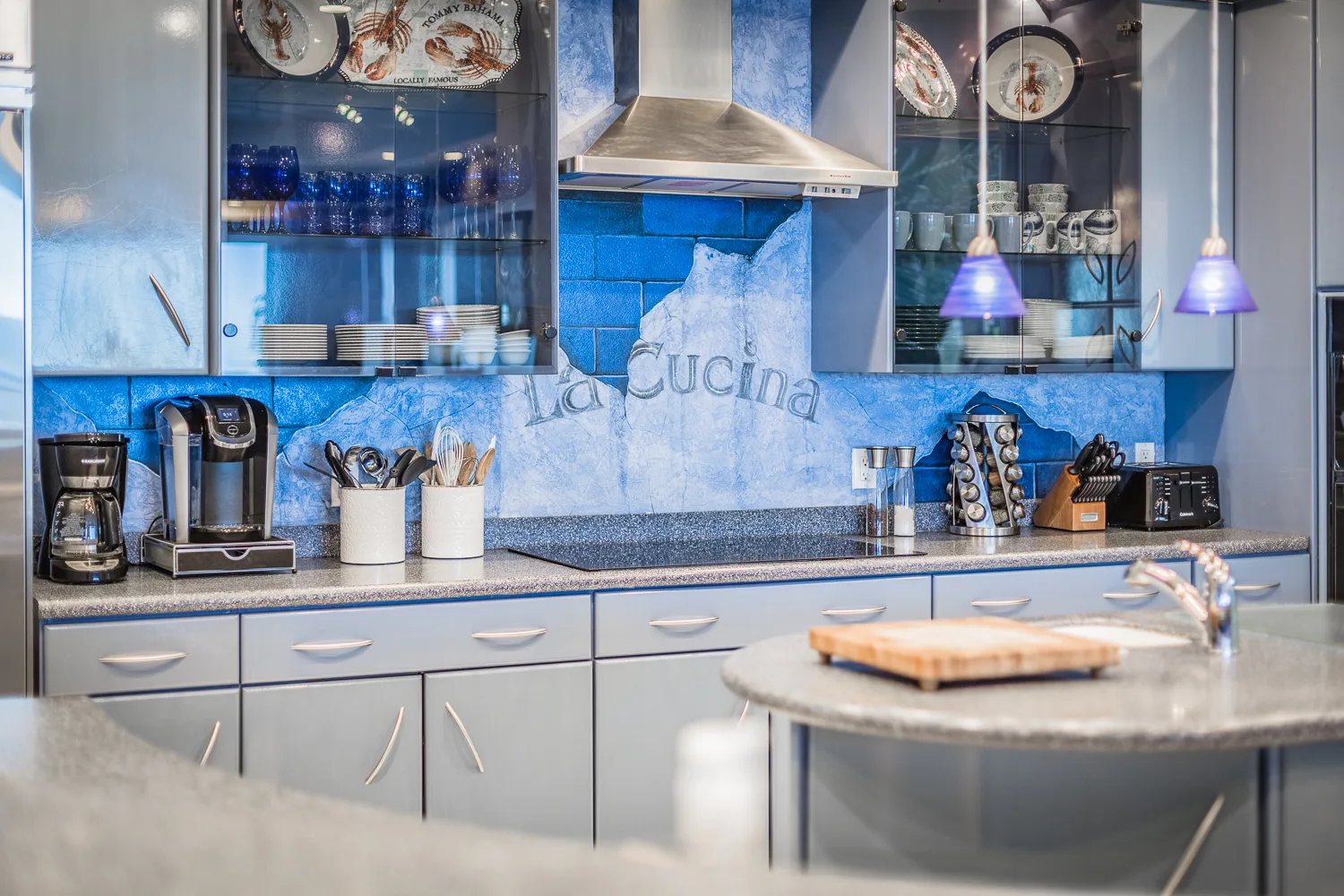 Kitchen counter with coffee station against hand-painted blue backsplash
